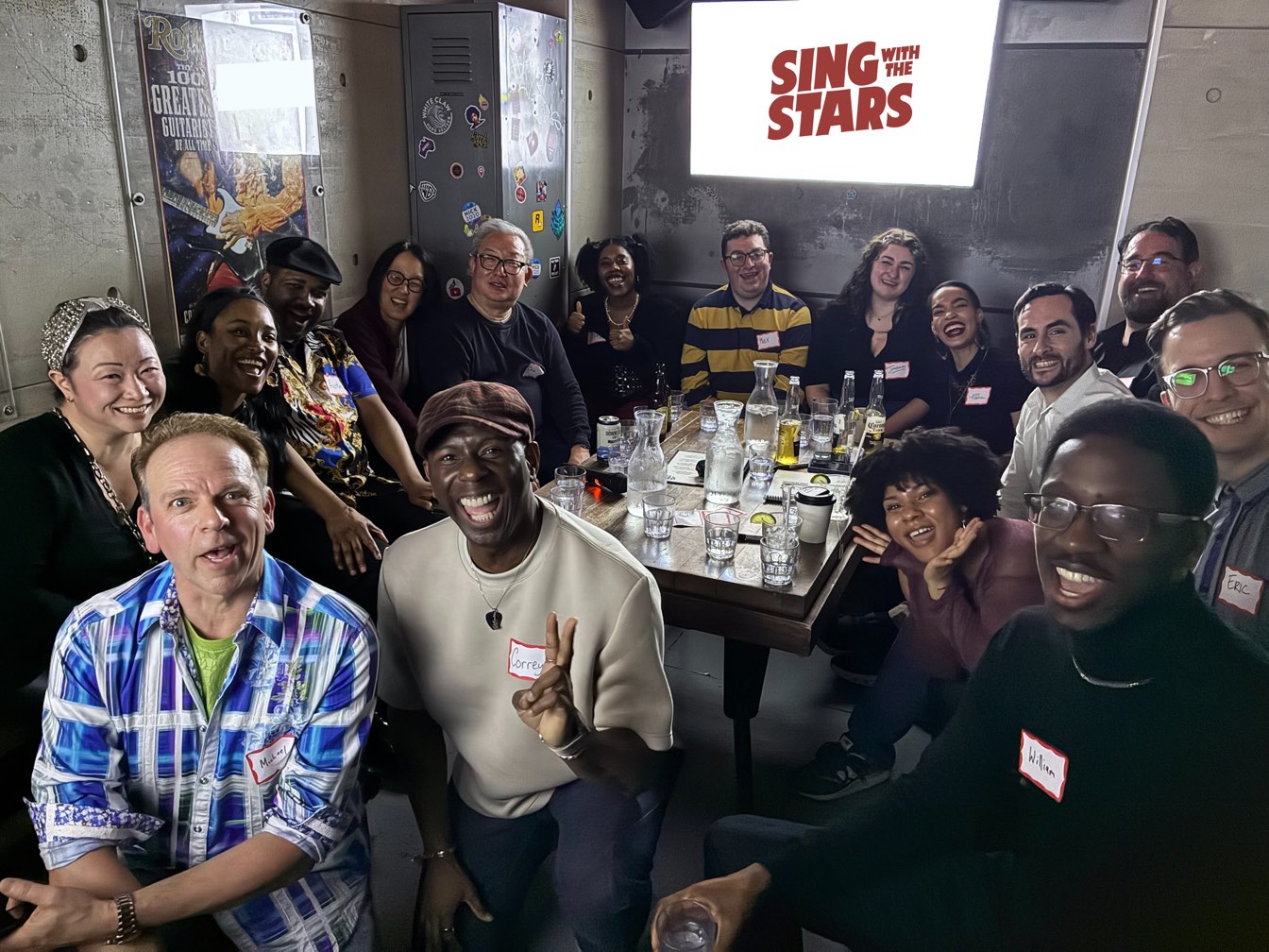 A full Sing With The Stars night: 16 guests and Broadway hosts around the table in a private Manhattan karaoke room