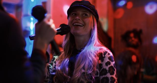 A delighted guest singing into the mic at an intimate Sing with the Stars night