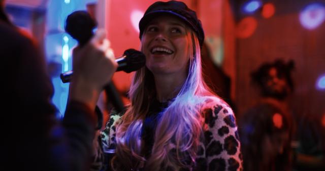 A delighted guest singing into the mic at an intimate Sing with the Stars night