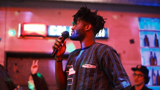 Guest singing into the mic at a Sing with the Stars night