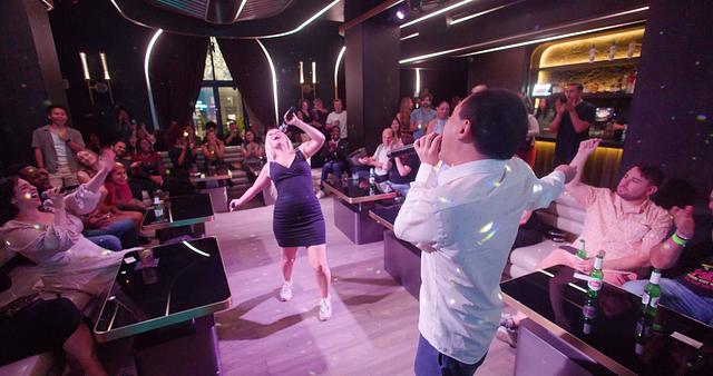 Guests smiling in elegant lounge while Broadway Star performs nearby; intimate private event